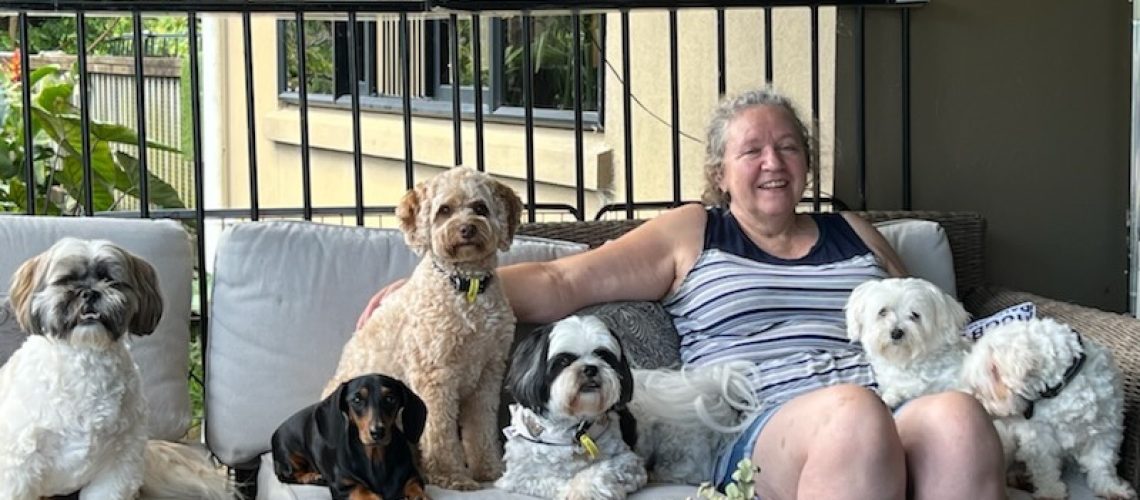 Raewyn, founder of K9andKats, outside with pet dogs